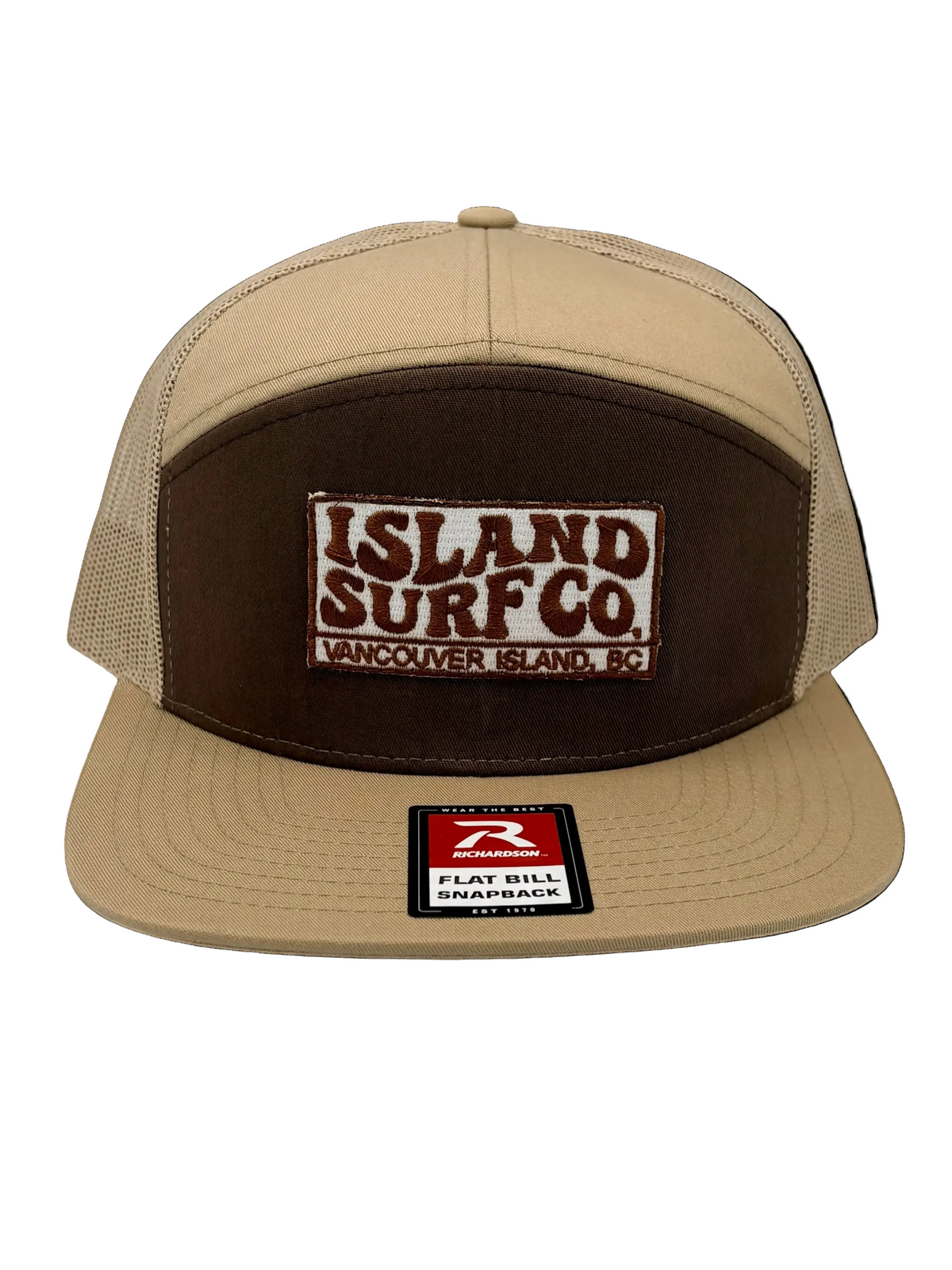 A beige and brown snapback trucker hat with a 'ISLAND SURF Co.' patch on the front and a 'Flat Bill Surfboards' sticker on the brim, shown against a plain white background.