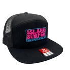 A black trucker-style snapback cap with a mesh back, featuring a colorful embroidered 'ISLAND SURF CO' patch on the front and a red and white Rip Curl flat bill sharpener sticker on the brim.